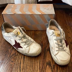 Golden Goose white sneaker with green sparkles and purple star